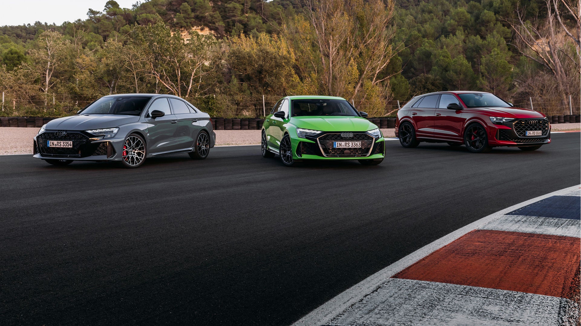 A blue Audi R8 parked with a man in a suit walking towards it.