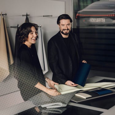 Andrea Haas and Stefan Bach in front of the sample wall.