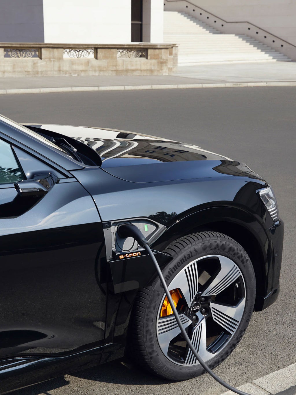 An Audi e-tron is being charged. 