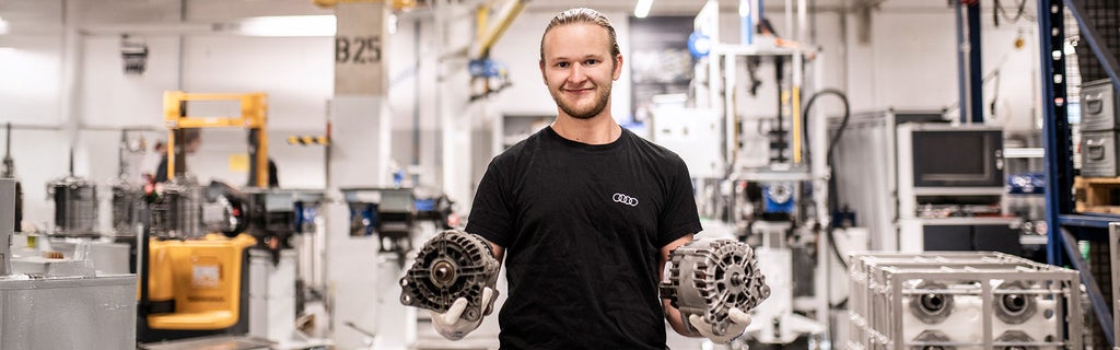 An employee presents two components in production