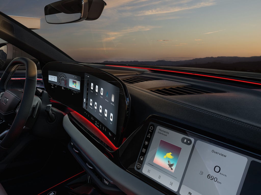 View of the passenger display, the MMI, and the steering wheel, from the passenger's perspective.
