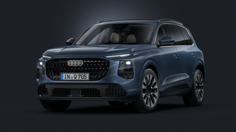 Vue de face en oblique du SUV Audi Q7 sur fond sombre.