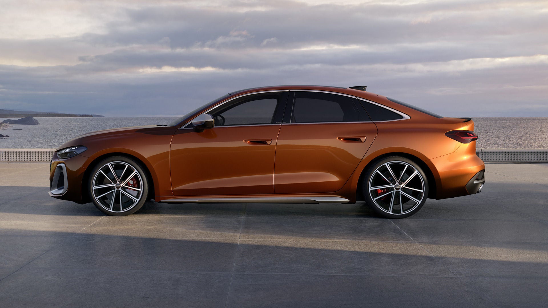 The S5 Saloon stands in profile on a promenade along the coast. The vehicle is painted in Ipanema Brown Metallic.