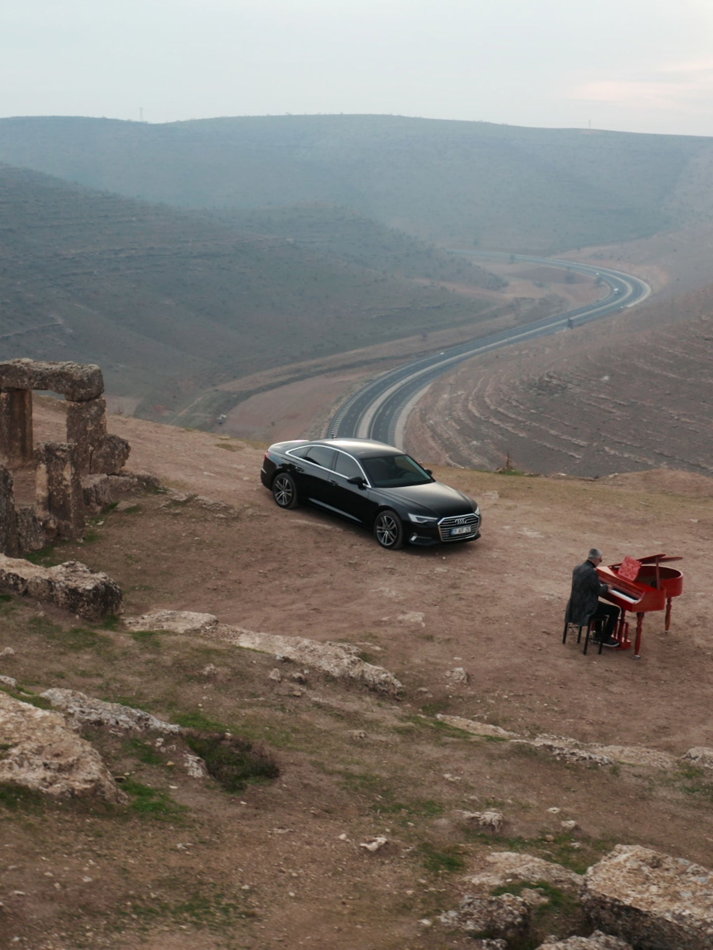 Audi RS e-tron GT sports car on a concrete surface in front of futuristic architecture