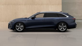 Blue A6 Avant parked aside a modern beige stone building