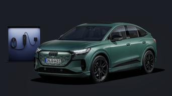 Der Q4 Sportback e-tron schräg von vorn auf dunklem Hintergrund, dahinter eine moderne Ladesäule.