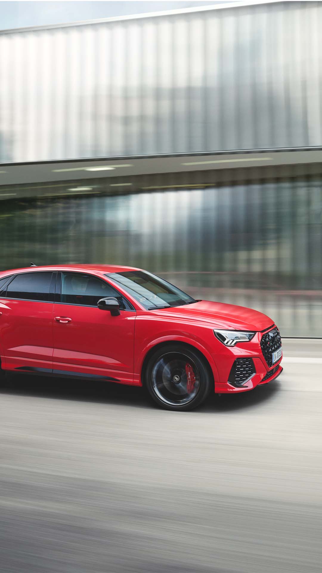 dynamic side view of the RS Q3 Sportback in tango red