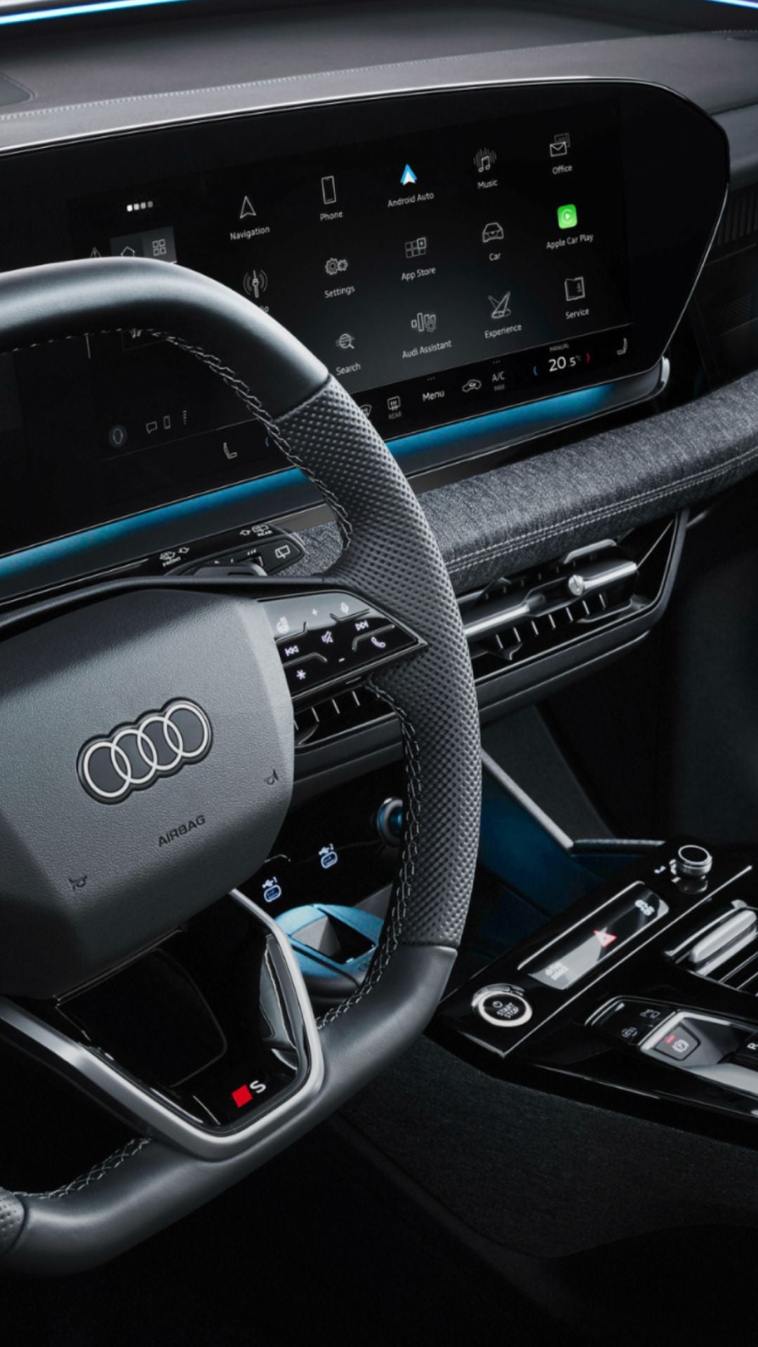 Interior view of an Audi vehicle showing the steering wheel and digital dashboard displays.