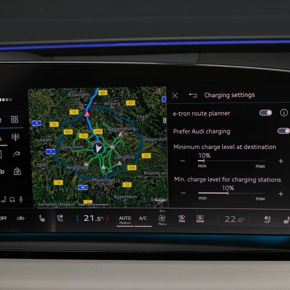 Interior view of an Audi vehicle with steering wheel, dashboard, and touchscreen display