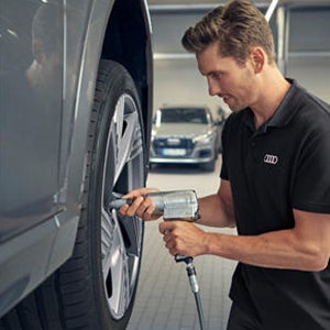 A mechanic checking on the breaks of a car