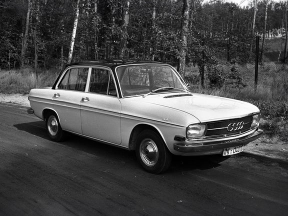 Black and white shot of a Union Audi car in front of trees