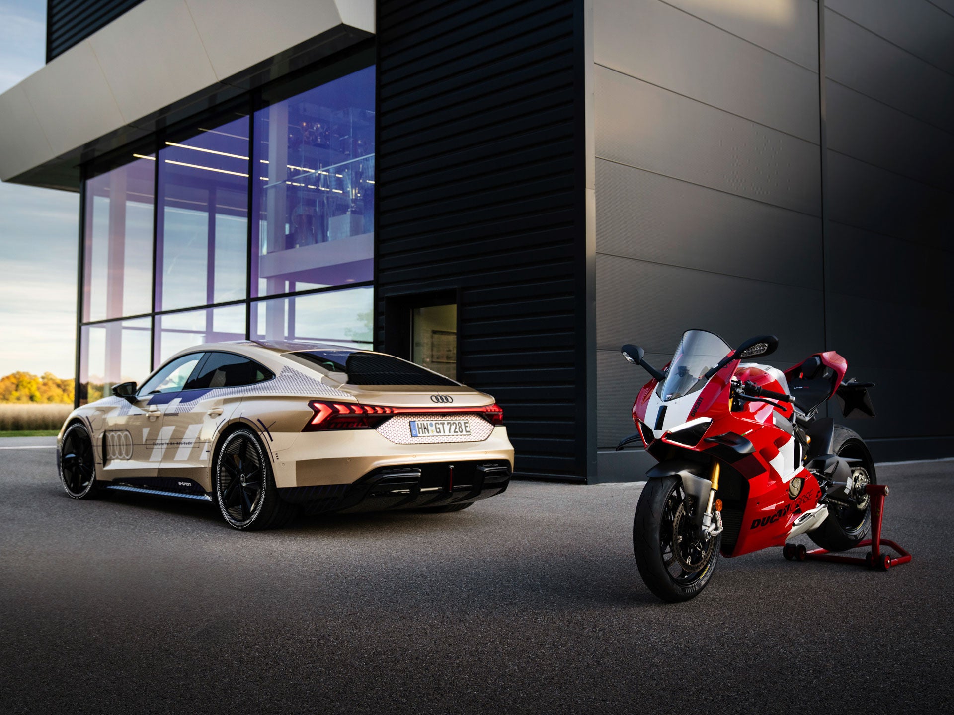 Rear view of the Audi e-tron GT next to the Ducati Panigale V4 R