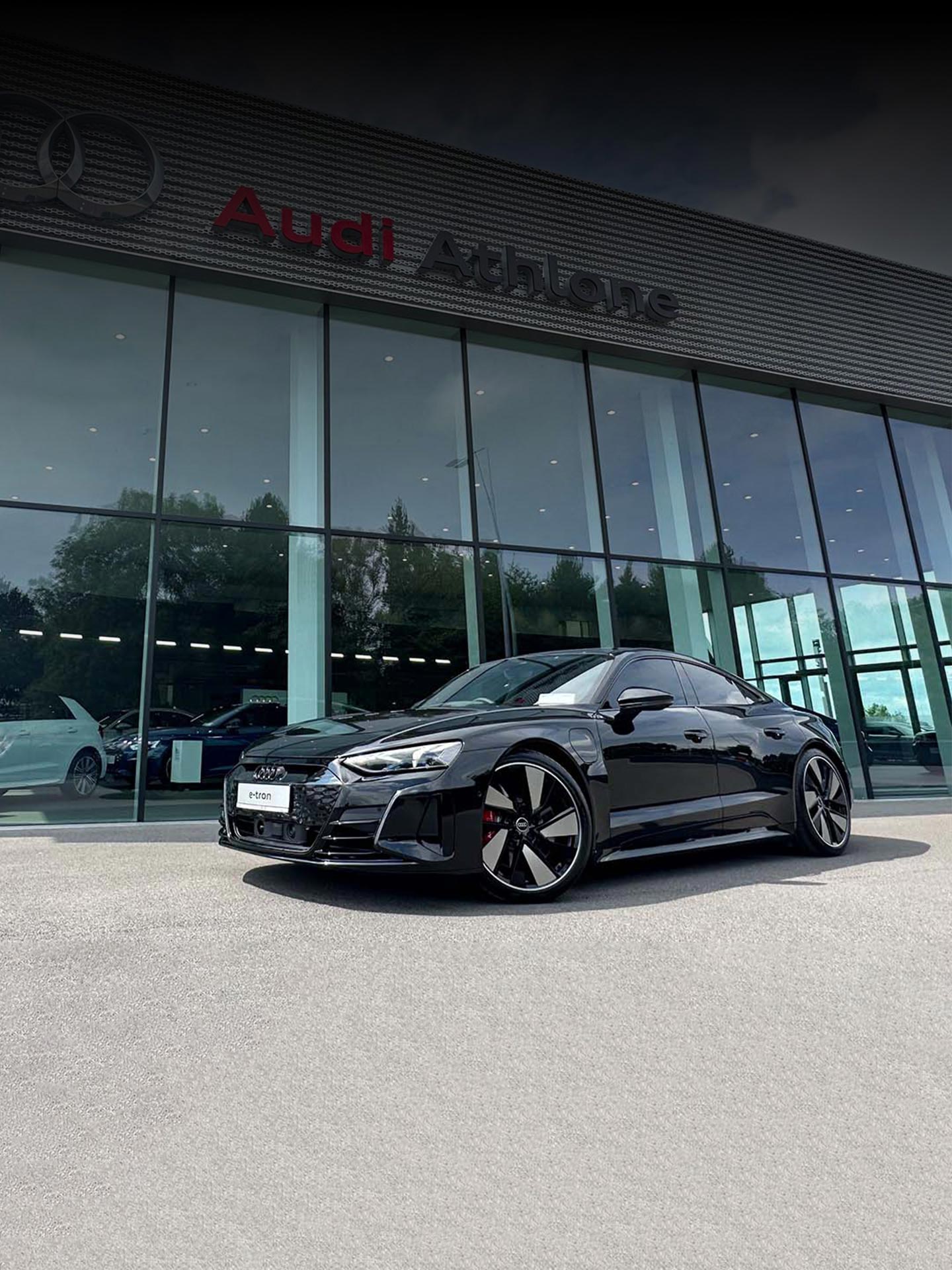 An Audi e-tron GT parked outside of Audi Athlone dealership.