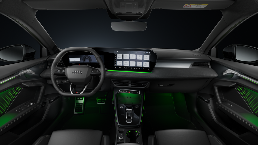 A front view of the cockpit, highlighting the sports leather steering wheel, the centre console, the curved panoramic display and the ambient lighting.