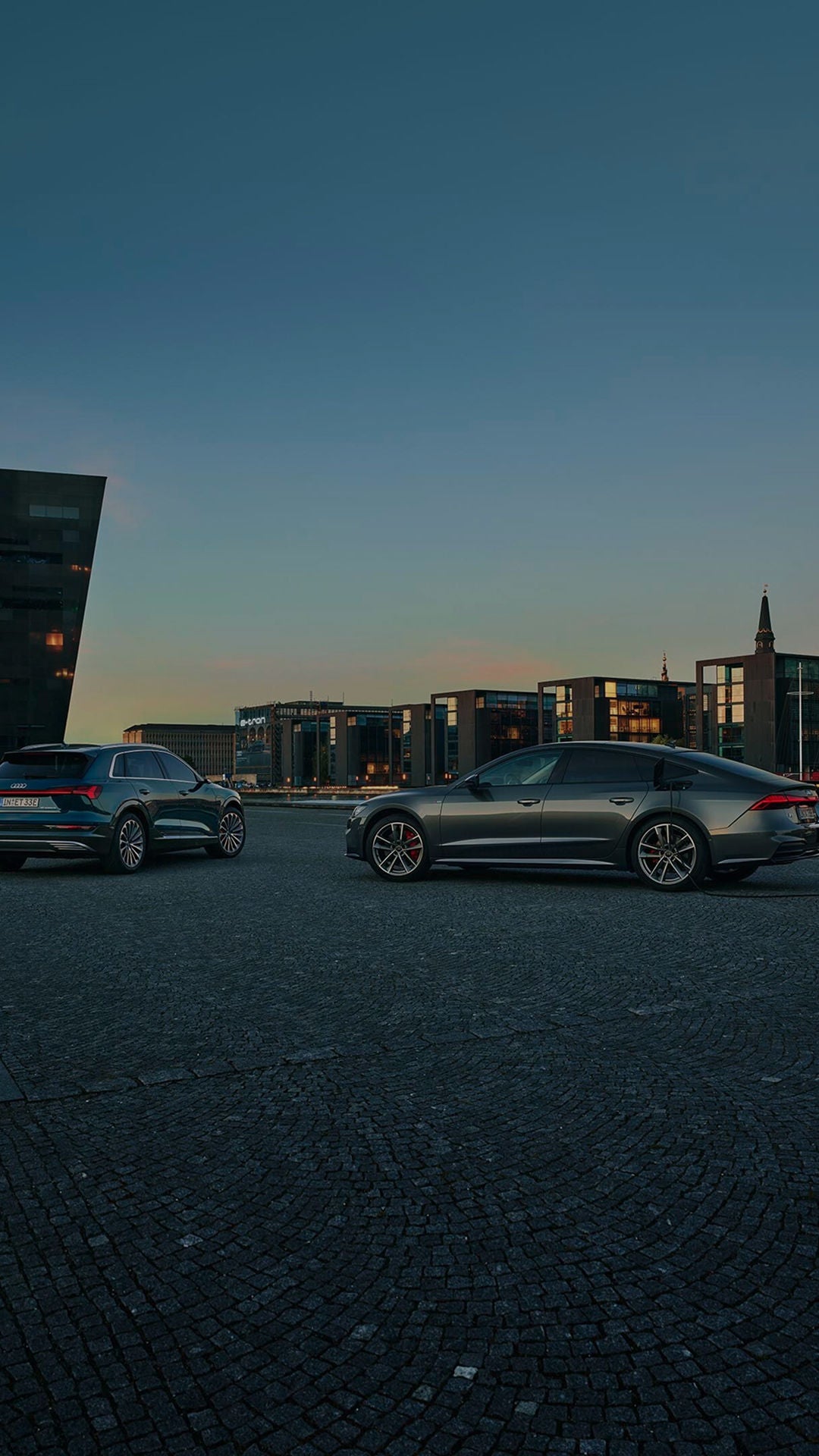 Two Audi cars next to each other near a harbour