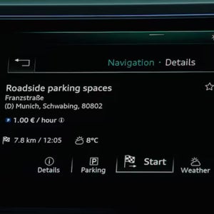 Close up of a car screen showing available parking spaces information