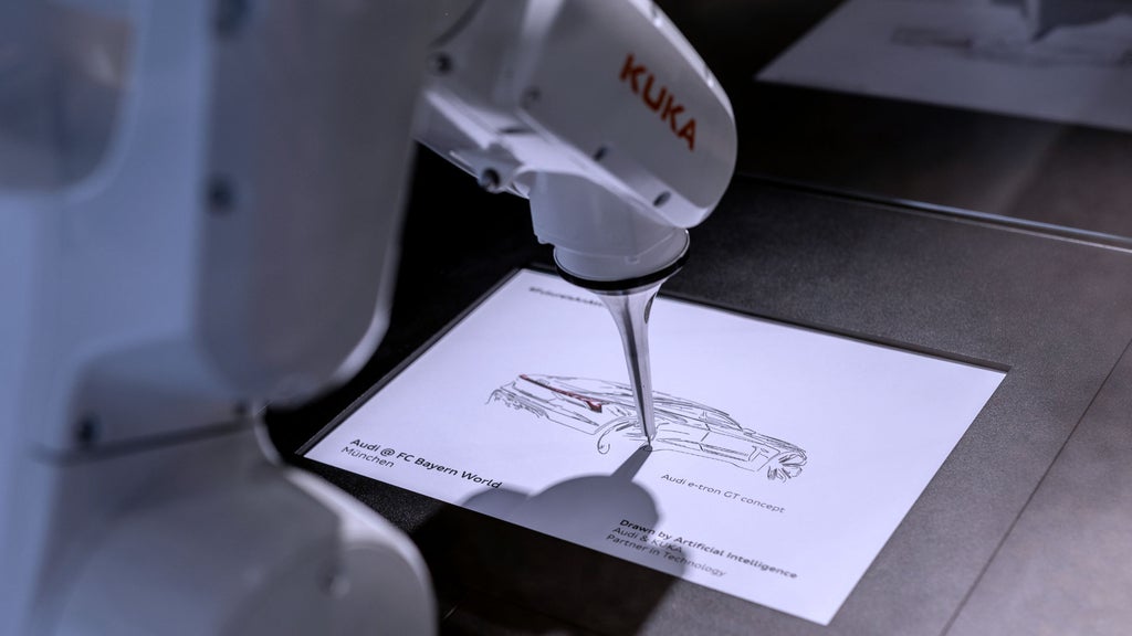 A robotic arm is drawing a sketch