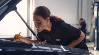 Audi service professional doing a visual check
