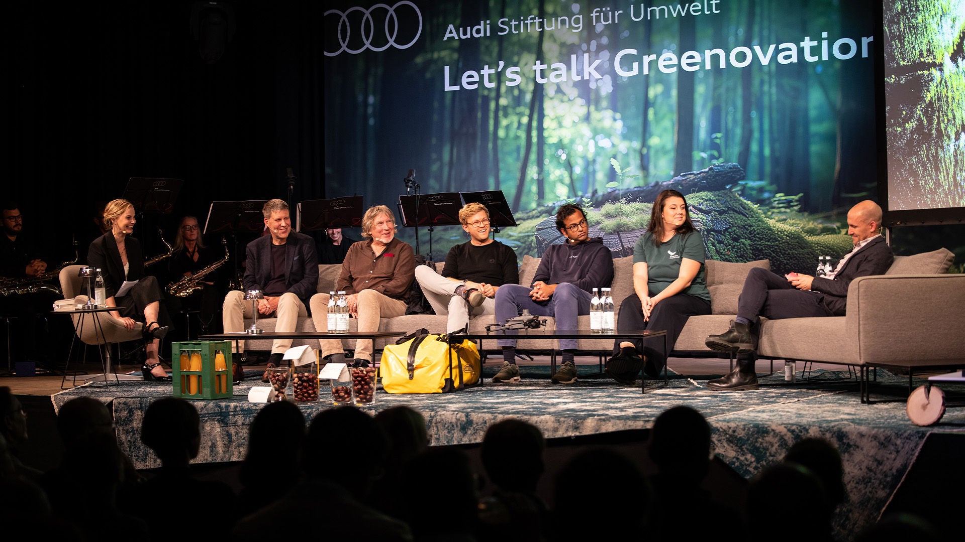 Speakers are sitting on a sofa.