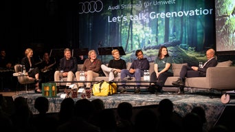 Speakers are sitting on a sofa.