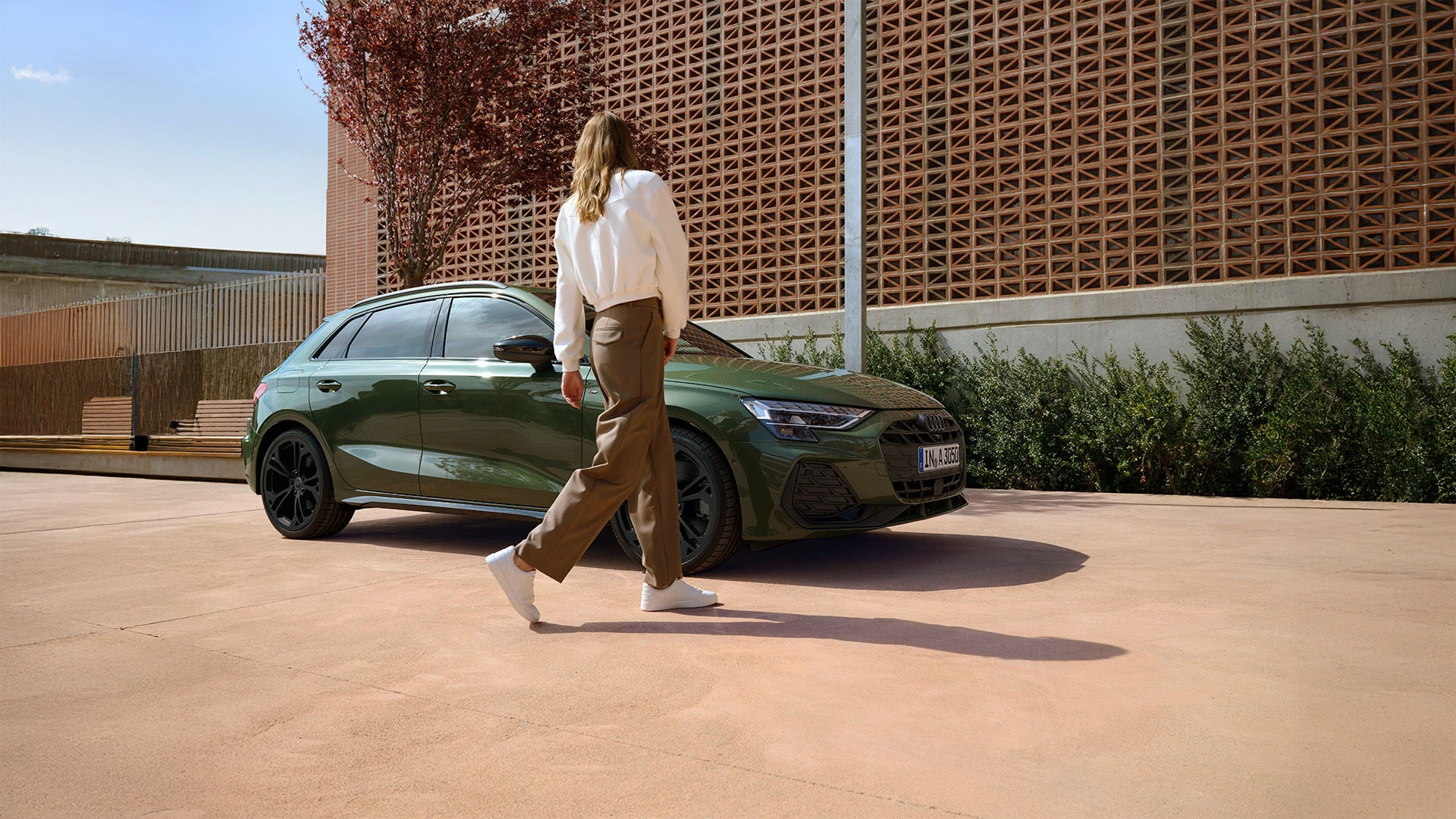 The new Audi SQ8 is prominently displayed in front of a modern building, showcasing its sleek design and luxury features.