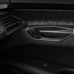 The inside of an Audi car door with forged carbon inlays