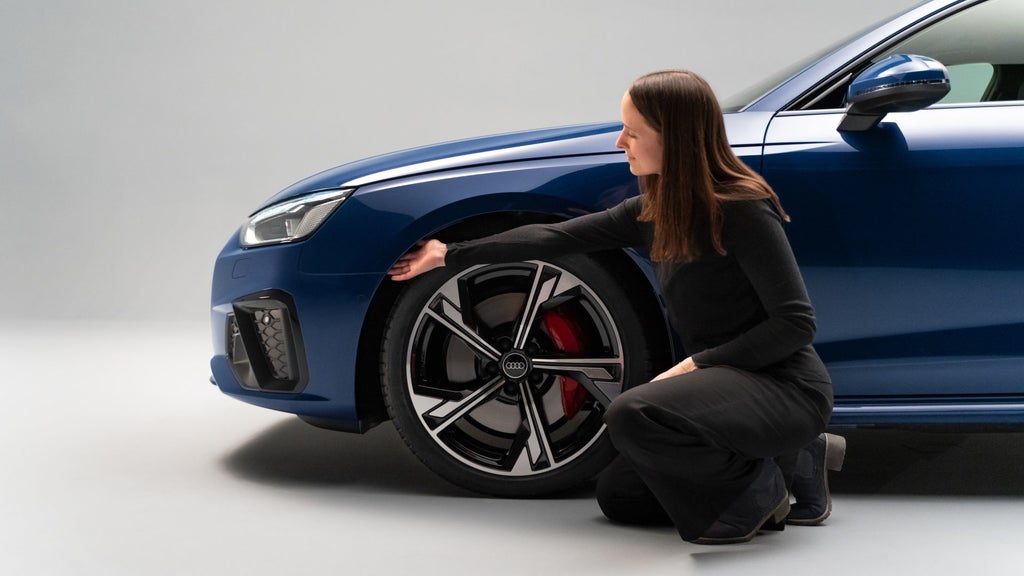 Jutta Schoberer is running her hand along the wheel arch.