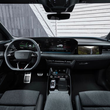 Interior view of an Audi vehicle showcasing dashboard, steering wheel, and infotainment system.