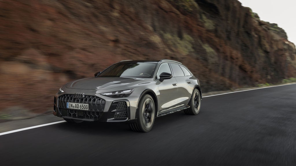 The new A6 allroad driving with mountains in the background