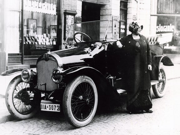 Black and white photo of a woman with a hat based on the Audi Type C Alpine Champion