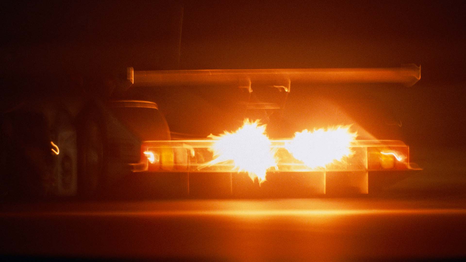 A picture showing spectacular exhaust flames from the back of an Audi R8C at Le Mans in 1999.