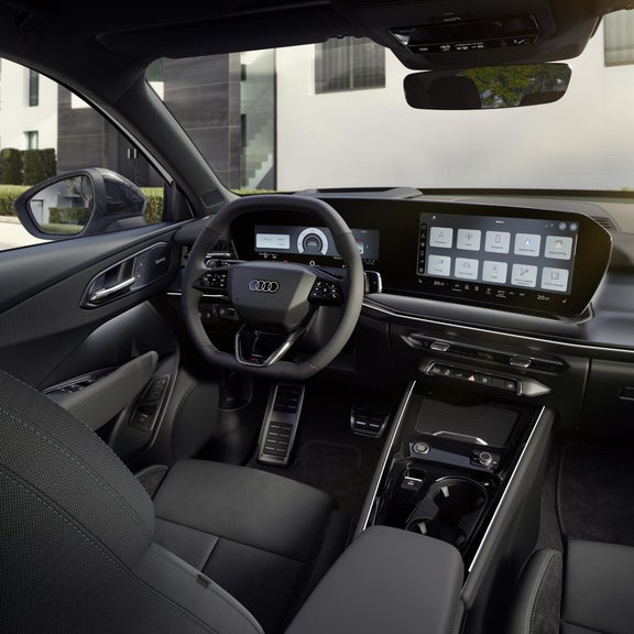 The cockpit of the Q3 SUV e-hybrid with a focus on the driver's instrument panel and the panoramic display.