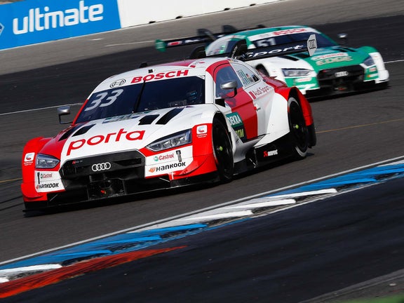 A picture showing two Audi RS 5 DTM race cars on track at the Hockenheim circuit.