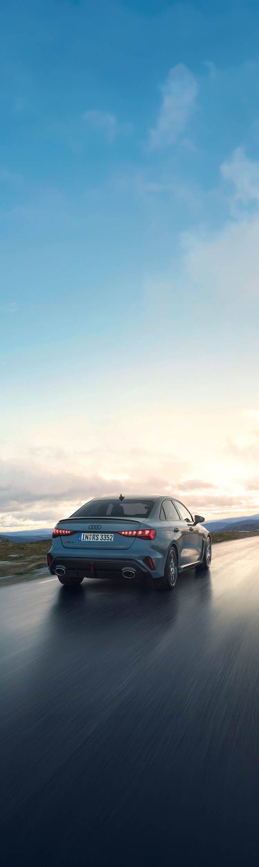 Audi RS 3 sedan on the road in side view