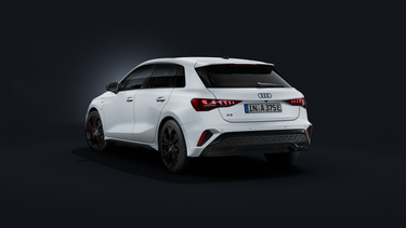 The Audi A3 Sportback e-hybrid, viewed from the rear at an angle against a dark background.