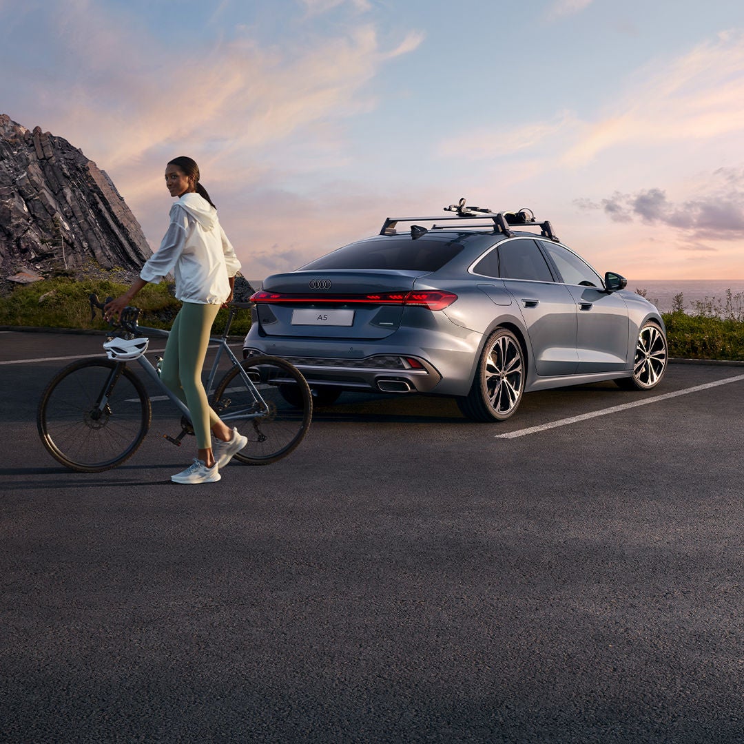 Close up of an Audi car seat, featuring the RS logo and red stiches