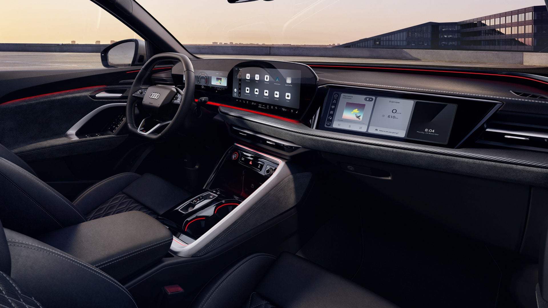 View through the passenger window into the cockpit of the SQ5 SUV. Among other things, you can see the panoramic display, the MMI passenger display, and the red ambient lighting.