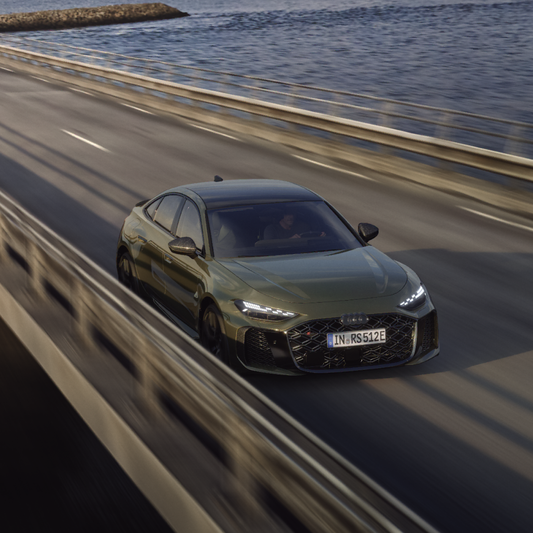 Green Audi RS 5 Saloon driving on a bridge