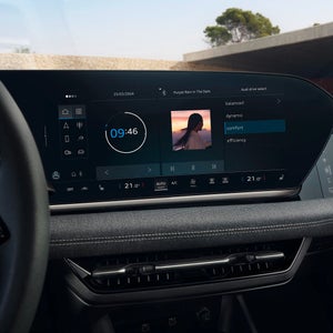 A modern car dashboard featuring a digital display with music controls, climate settings, and a clock showing 9:46 on March 25, 2024.