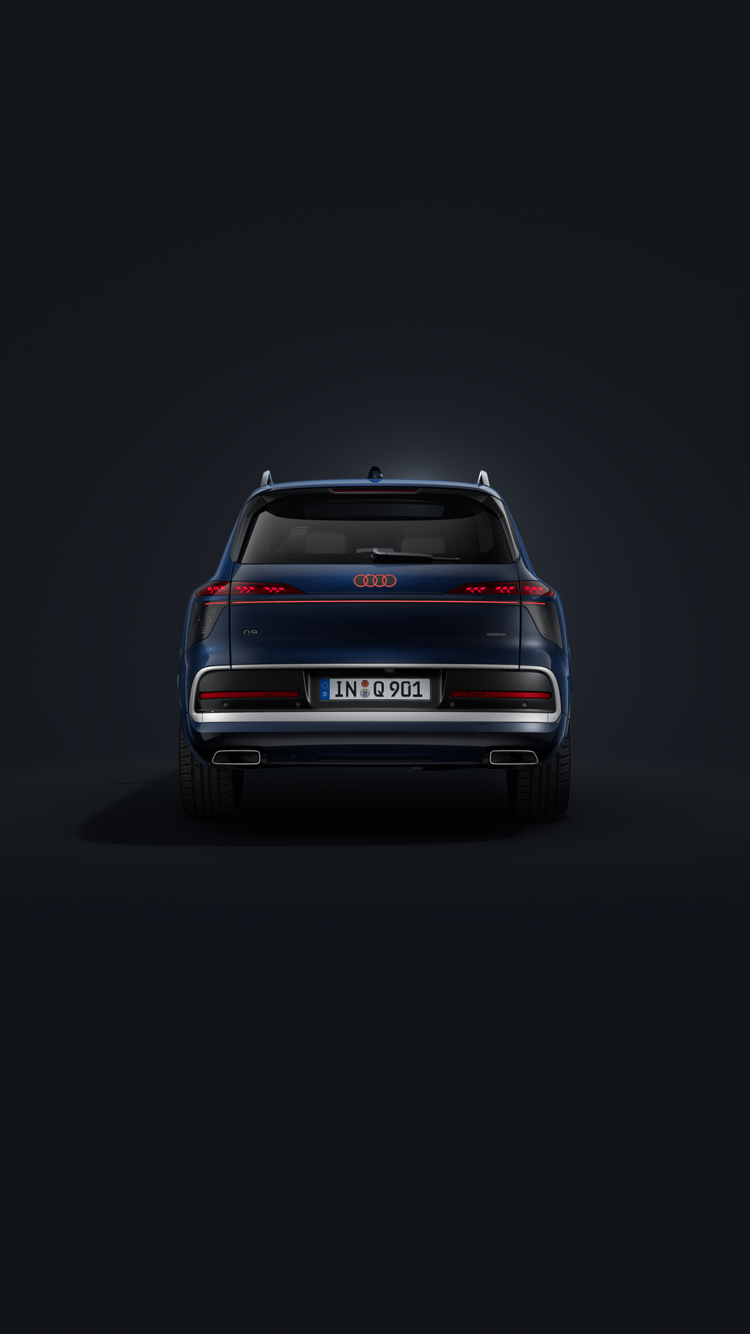 The Audi Q9 SUV, viewed from the front at an angle against a dark background.
