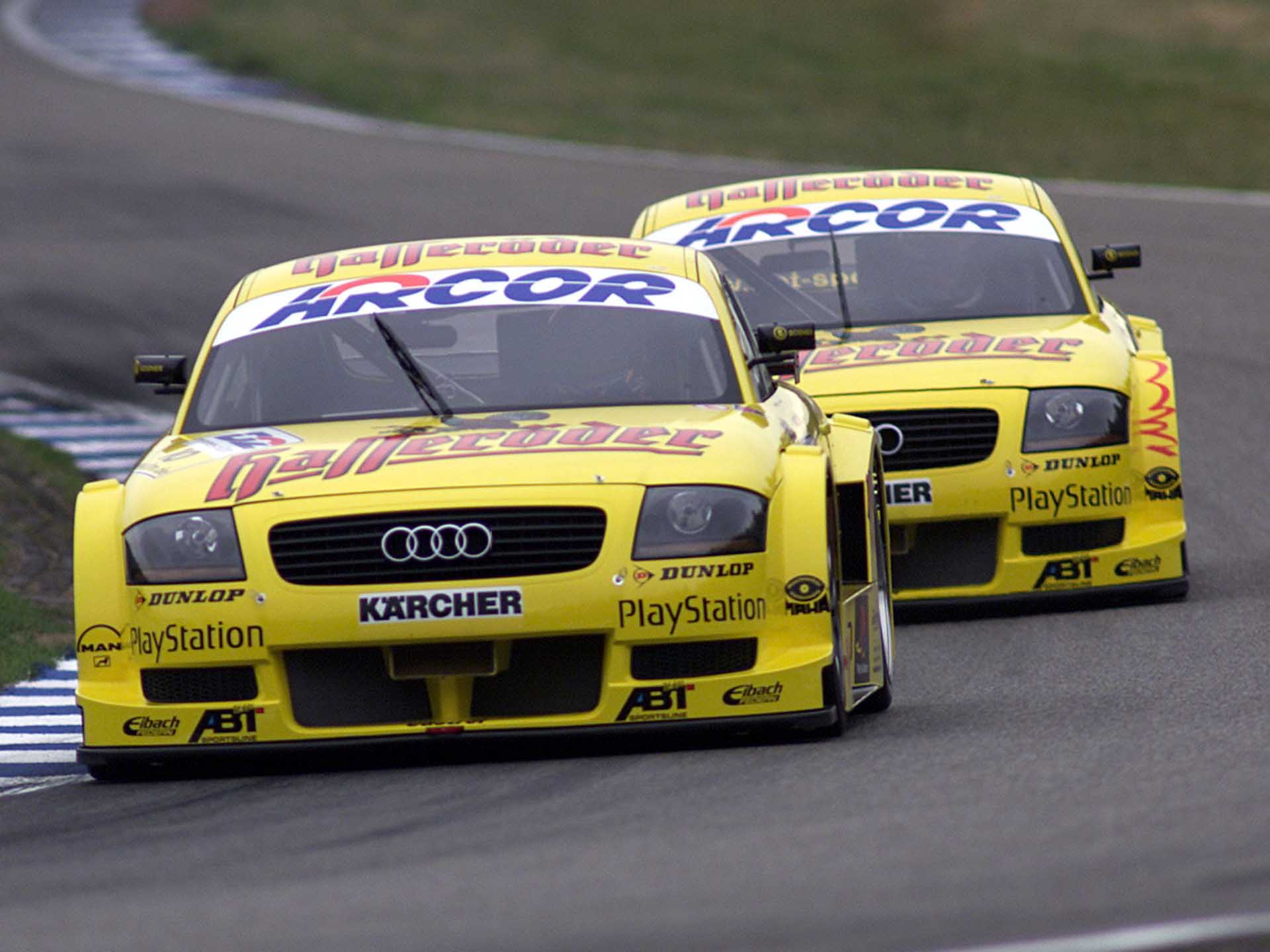 A picture showing two Abt-Audi TT-R race cars on track in 2000.