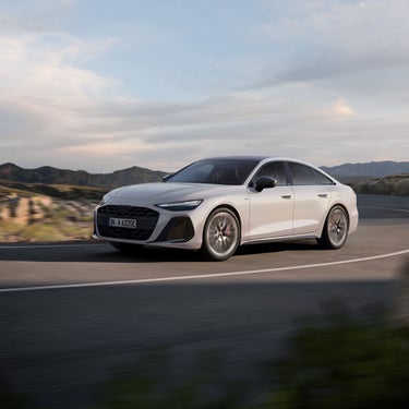  Audi A6 Sedan side front view in a dynamic drive in the mountains