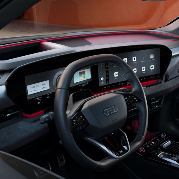 The dashboard and panoramic displays as seen from the passenger's perspective. The interaction light can be seen glowing red below the windshield.