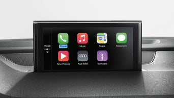 Ein Smartphone-Interface auf einem schwarzen Dashboard. Es sind einige Applikationen auf dem Display zu sehen.