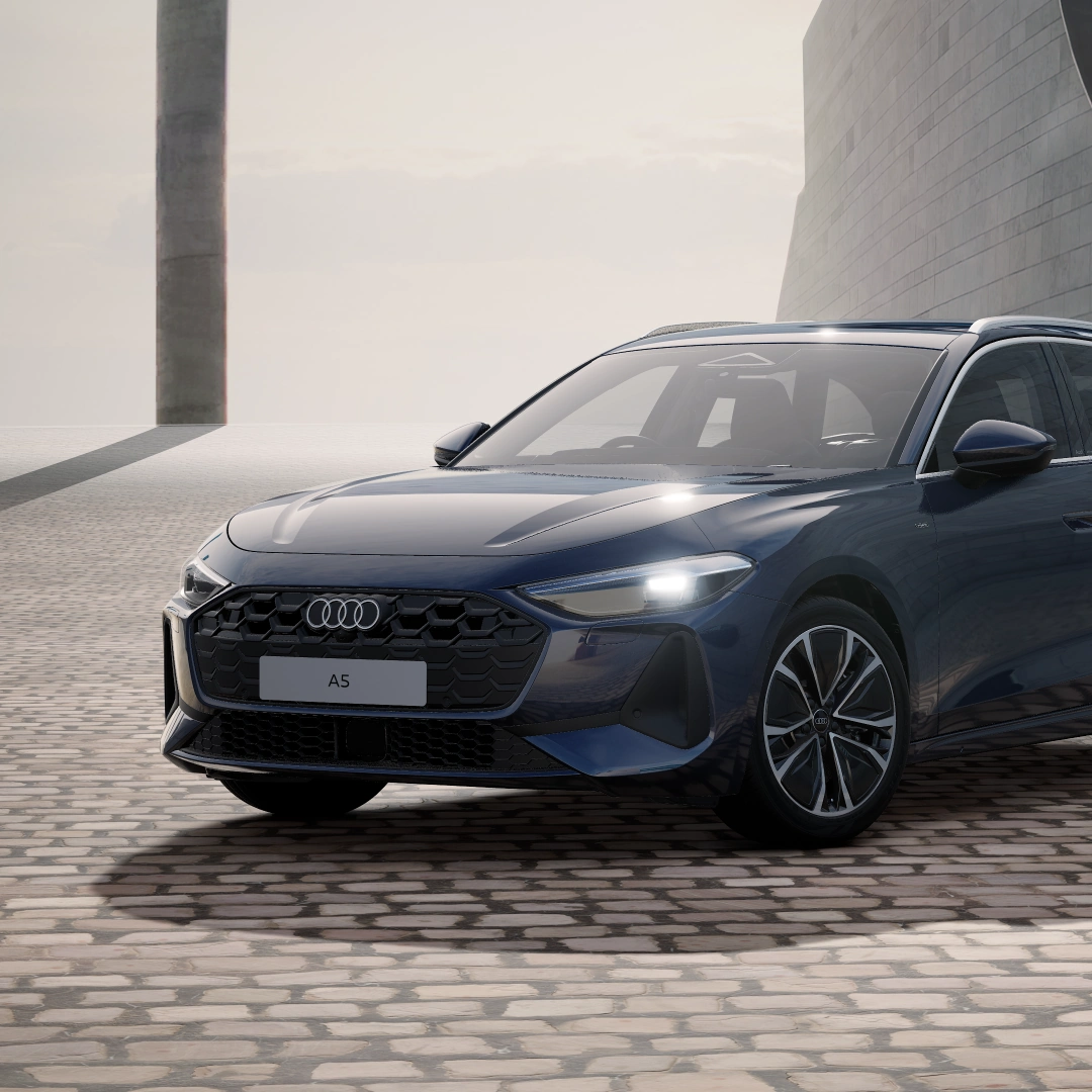 Front three-quarter view of a dark grey Audi A5 Avant e-hybrid.