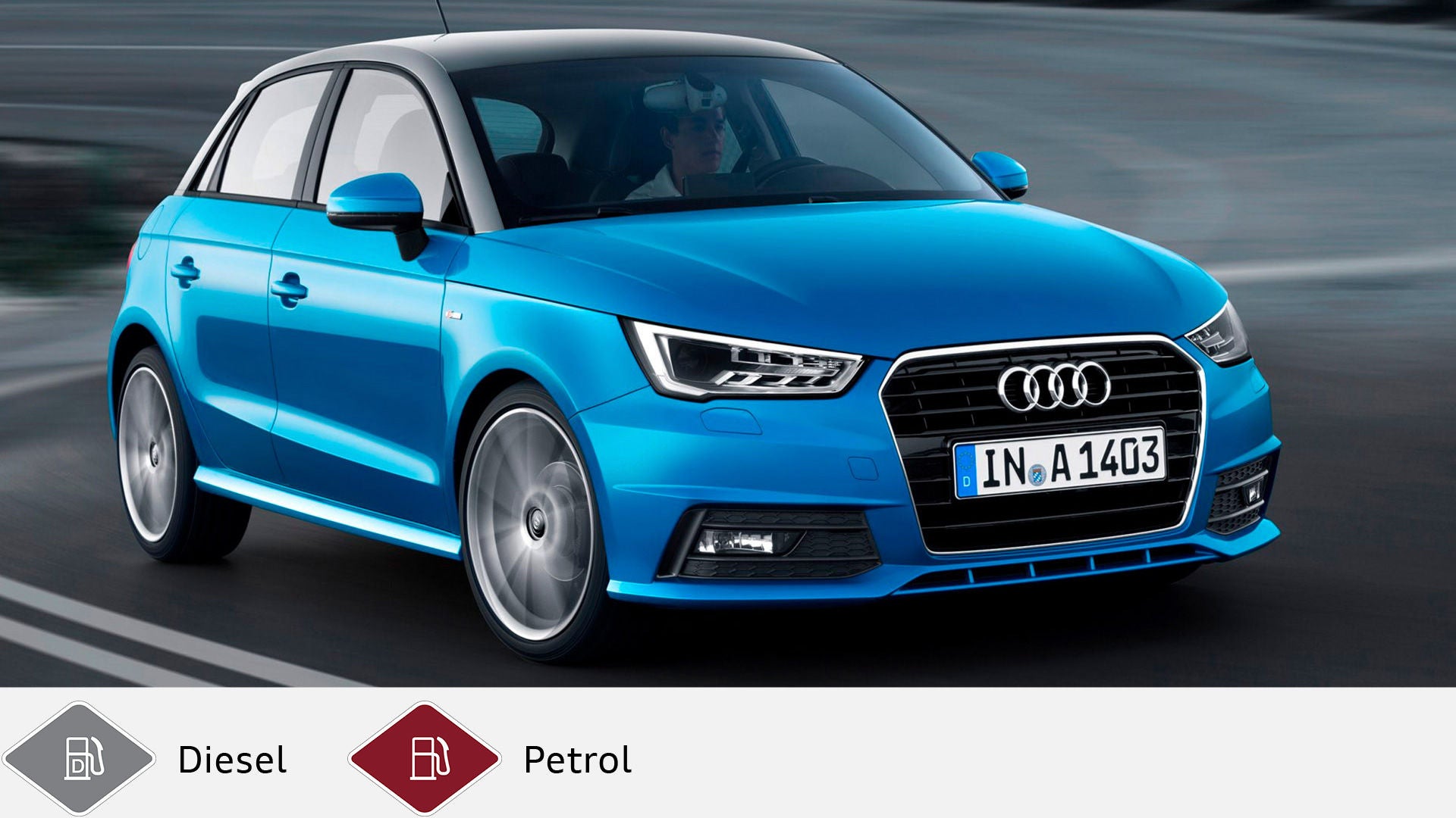 Blue Audi A1 Sportback driving on a country road, photographed slightly from the front. Gray diesel symbol and red petrol symbol at the bottom.