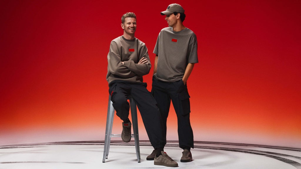 A picture showing Nico Hulkenberg and Gabriel Bortoleto wearing clothing from the team’s collection from adidas.