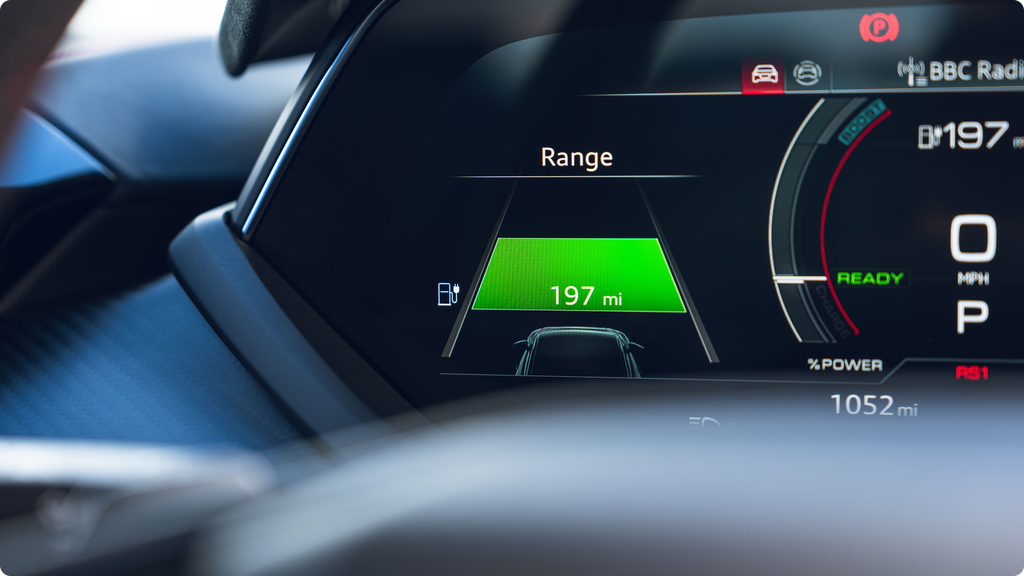 Car dashboard display showing range 197 miles, speed 0mph, battery level and power usage.