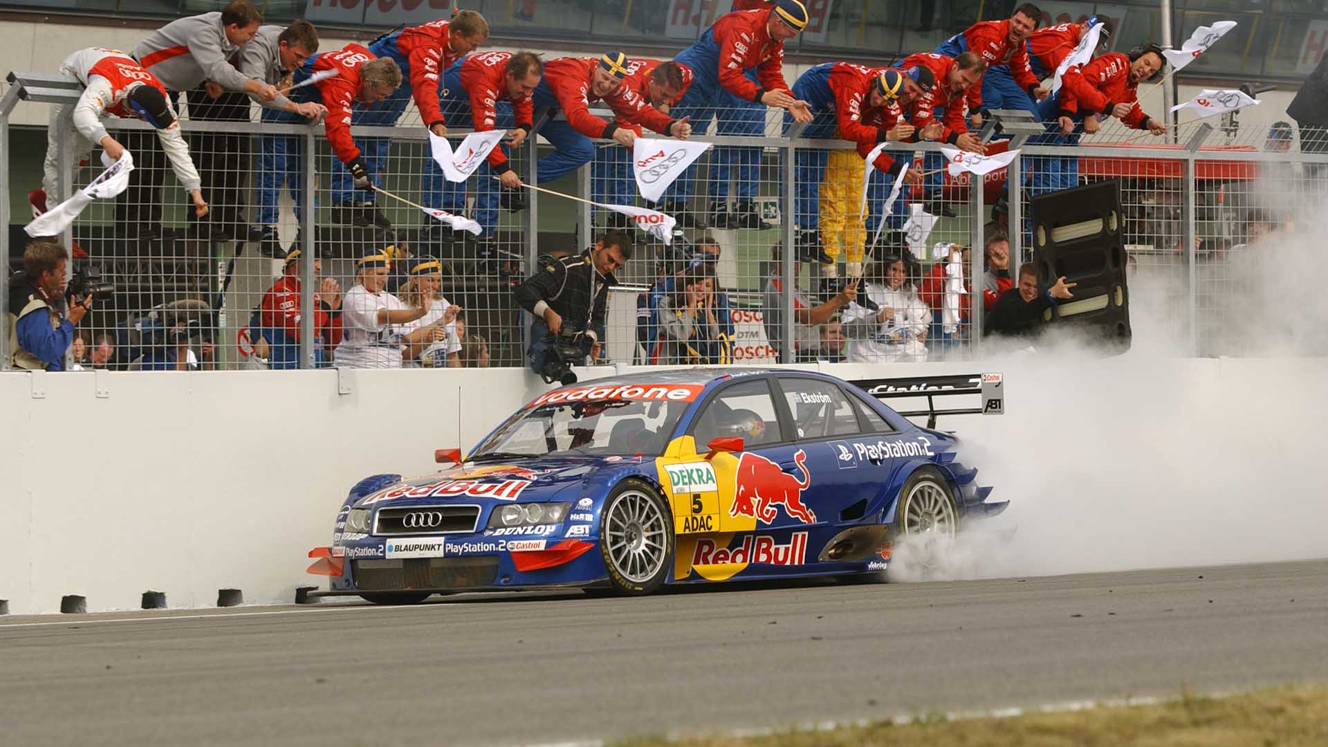 A picture showing Mattias Ekström’s Audi A4 DTM race car taking victory at Brno in 2004.