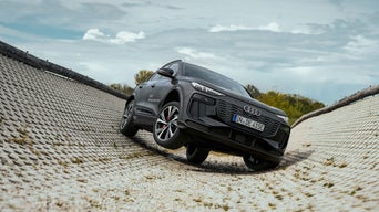 Gray Audi SQ6 SUV e-tron on a training ground.